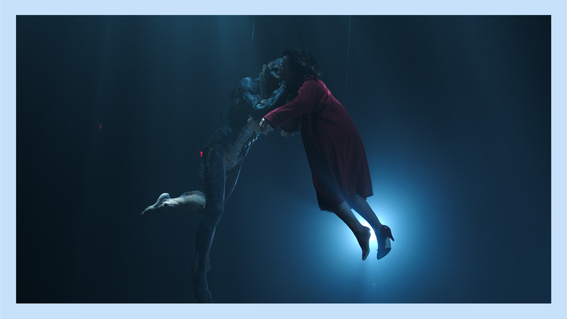 The asset and the lead of Shape of Water hang by wires in an "underwater" world.