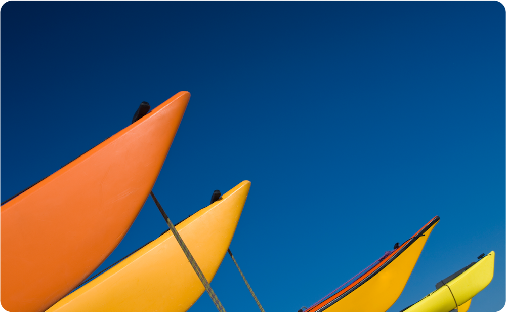 artsy photograph of kayaks pointing up toward the sun