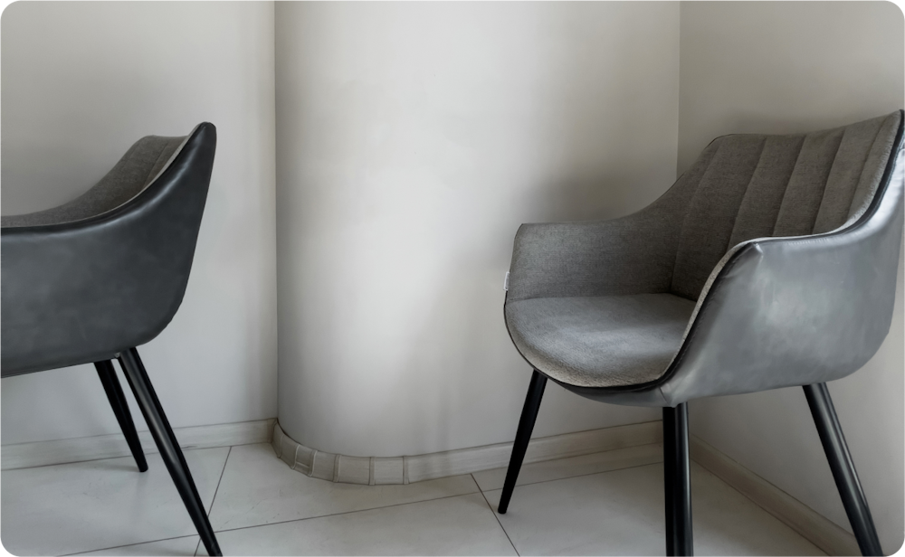 greyscale image of two cloth chairs